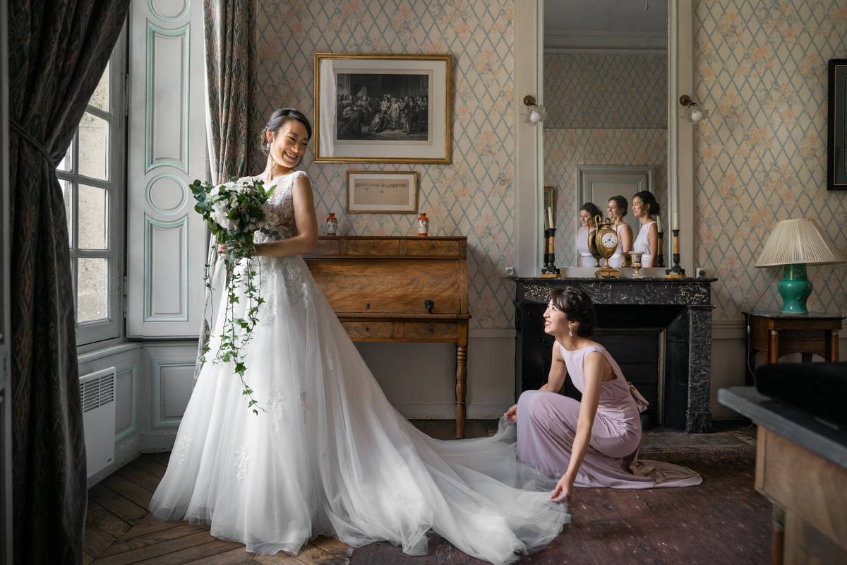 préparatifs de la mariée dans une chambre avec ses demoiselles d'honneur